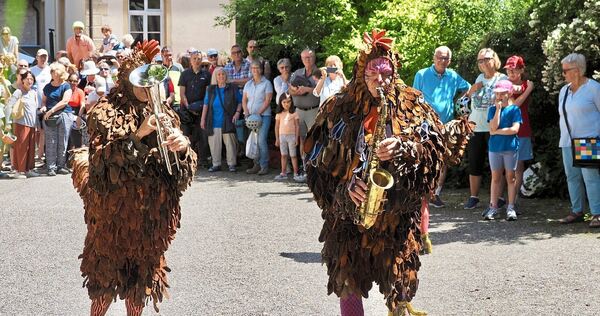 Die Straßenkünstlergruppe PasParTouT in ihren prachtvoll gefiederten Kostümen. Die Straßenkünstlergruppe PasParTouT in ihren prachtvoll gefiederten Kostümen.