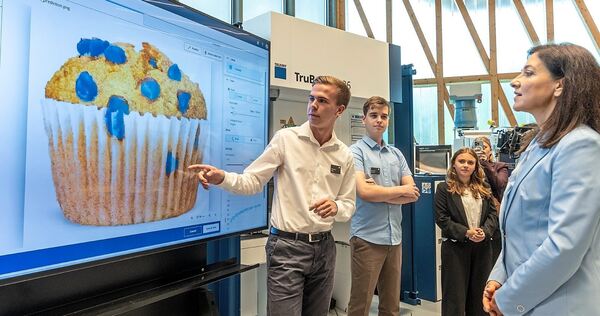 Bundeswirtschaftsministerin Katherina Reiche zu Besuch bei Trumpf: Anhand eines Muffins erklären die Auszubildenden, wie sie ihr Bundeswirtschaftsministerin Katherina Reiche zu Besuch bei Trumpf: Anhand eines Muffins erklären die Auszubildenden, wie sie ihre KI trainieren.