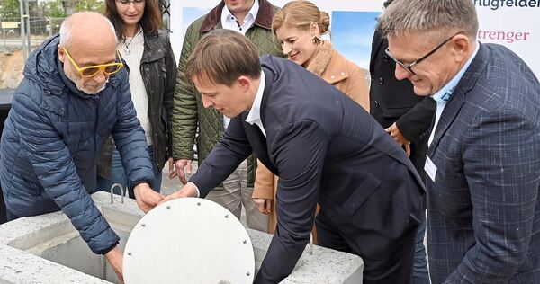 Die Zeitkapsel wird von Jürgen Pflugfelder (links) und Daniel Hannemann (Strenger, vor Lis Hannemann-Strenger) in dem Quader ver Die Zeitkapsel wird von Jürgen Pflugfelder (links) und Daniel Hannemann (Strenger, vor Lis Hannemann-Strenger) in dem Quader versenkt. Zuvor hatten OB Matthias Knecht mit Bürgermeisterin Andrea Schwarz (hinten links), Julian Pflugfelder (2.v.r.), Han
